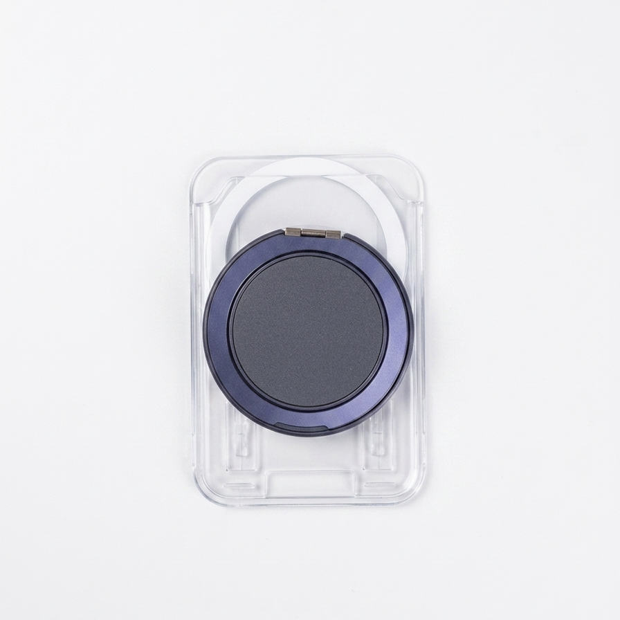 Black circular object in a clear plastic packaging on a white background