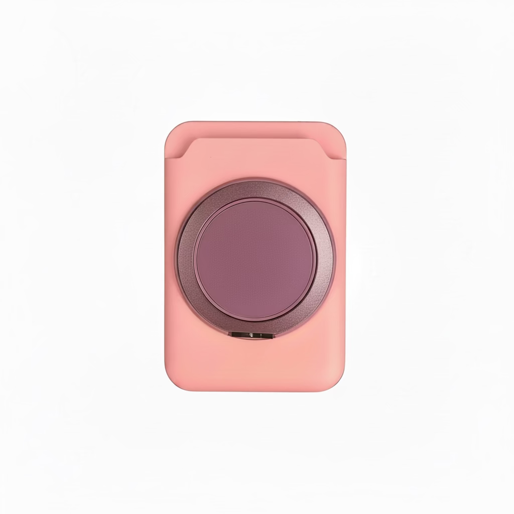 Pink square object with a round purple center held in a hand against a blurred background