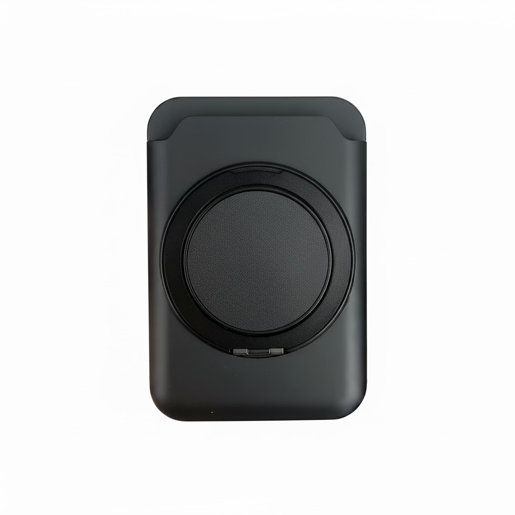 Black wireless charger held in a hand with a blurred background